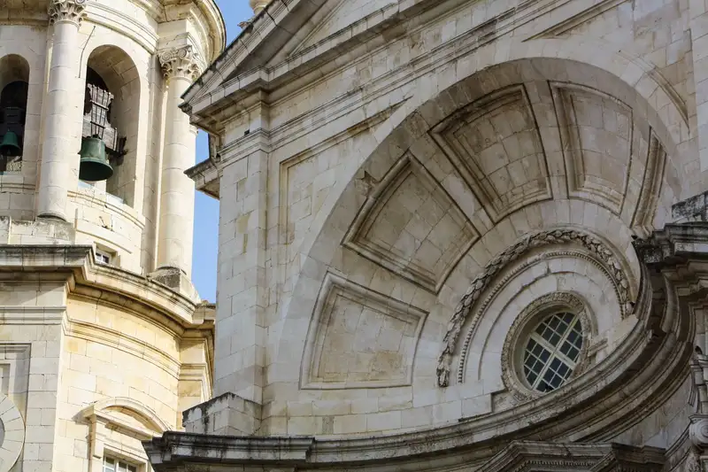 Close-up of Cádiz Cathedral's intricate architecture and bell tower.